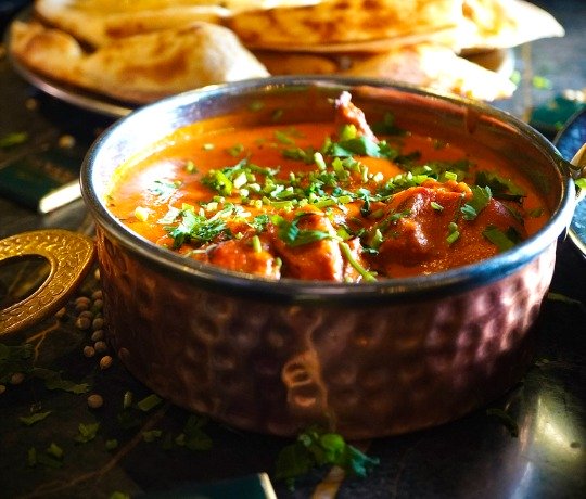 Best Curry In Scotland Close up of a bowl of curry with out of focus people in the background